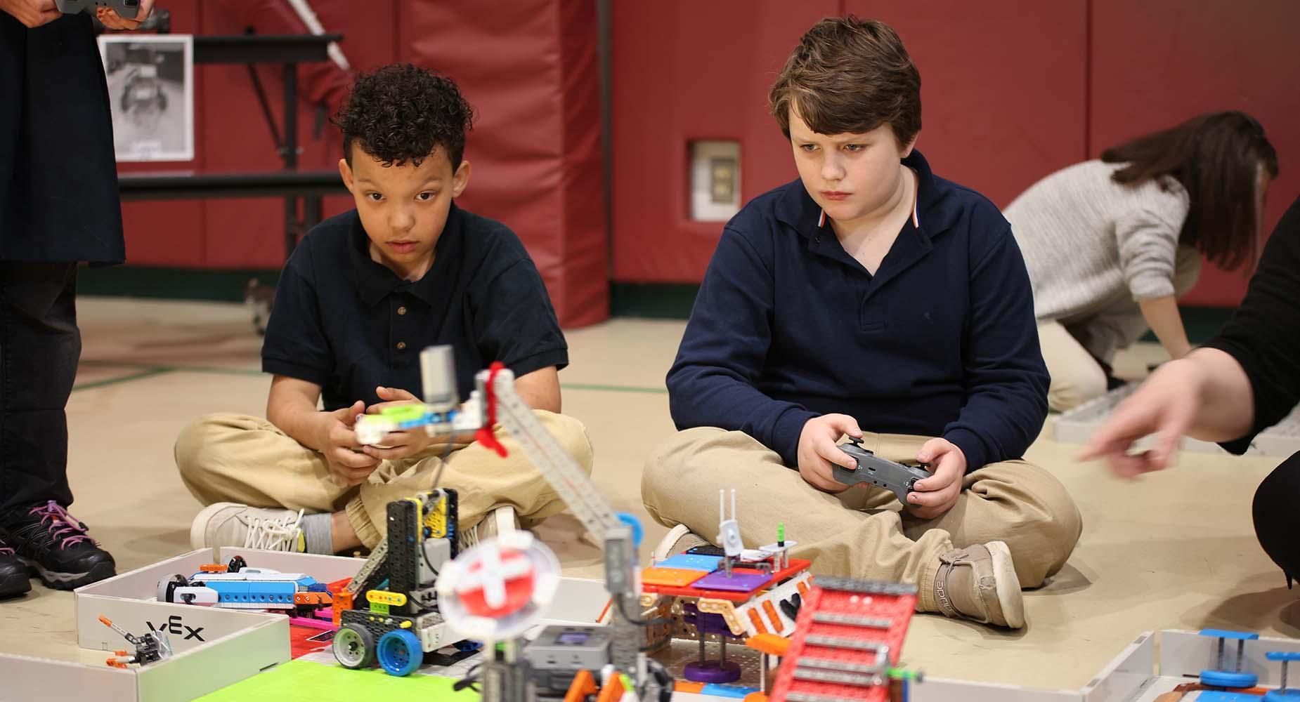 HSA New Bedford students controlling robots to navigate a maze.