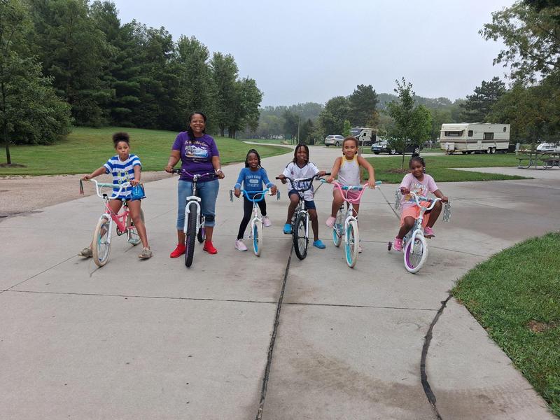 Scholars and the principal riding their bikes