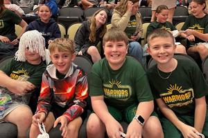 Sunrise Elementary students Makson McCloy, Kamryn Champion, Nick Caito, and Landon Baughman enjoy the game from their arena seats
