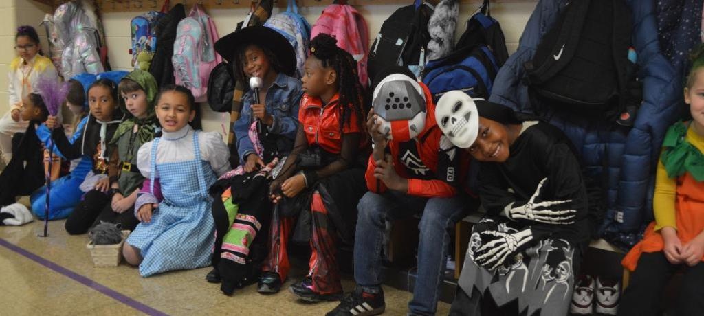 several costumed students line up in hallway