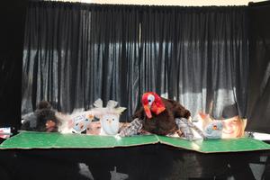 puppets peeking through a curtain