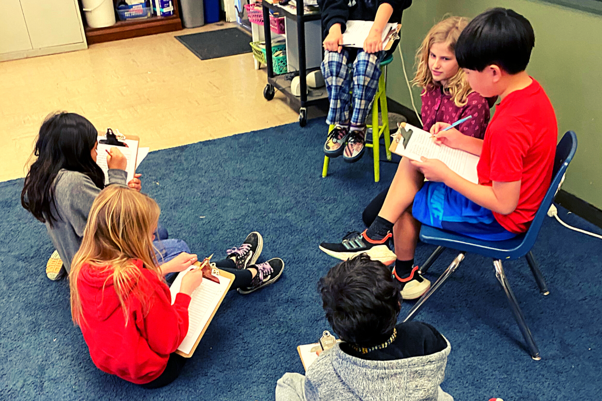 Students discuss what they've learned about molecules and organisms for their research project