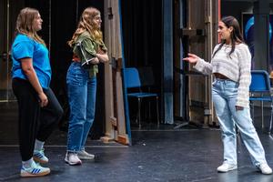 Livia talks stage direction with two performers