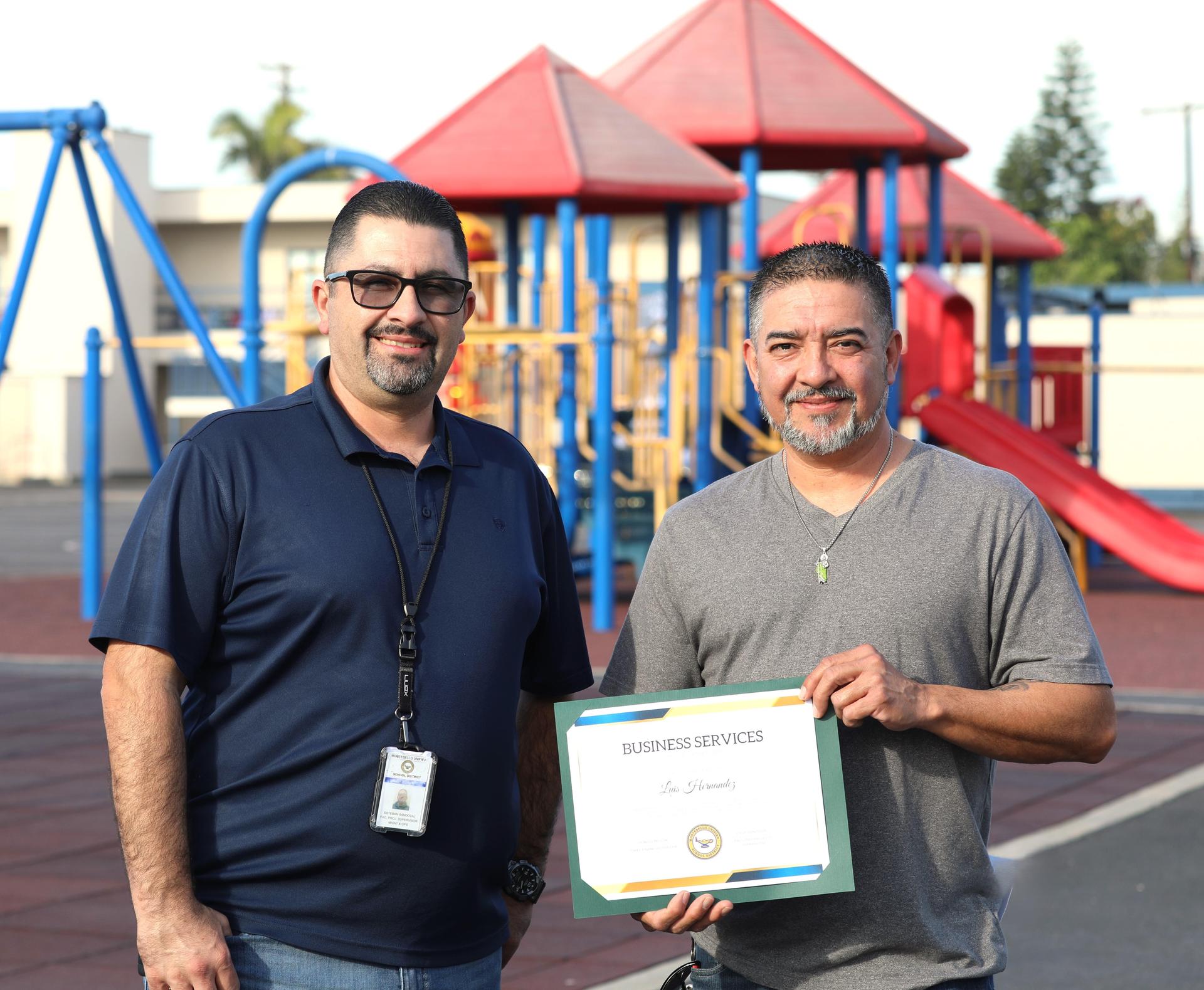 Picture of employee holding certificate 