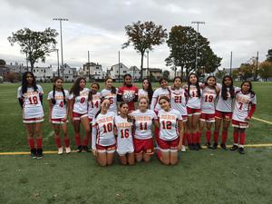 girls soccer team standing together at field