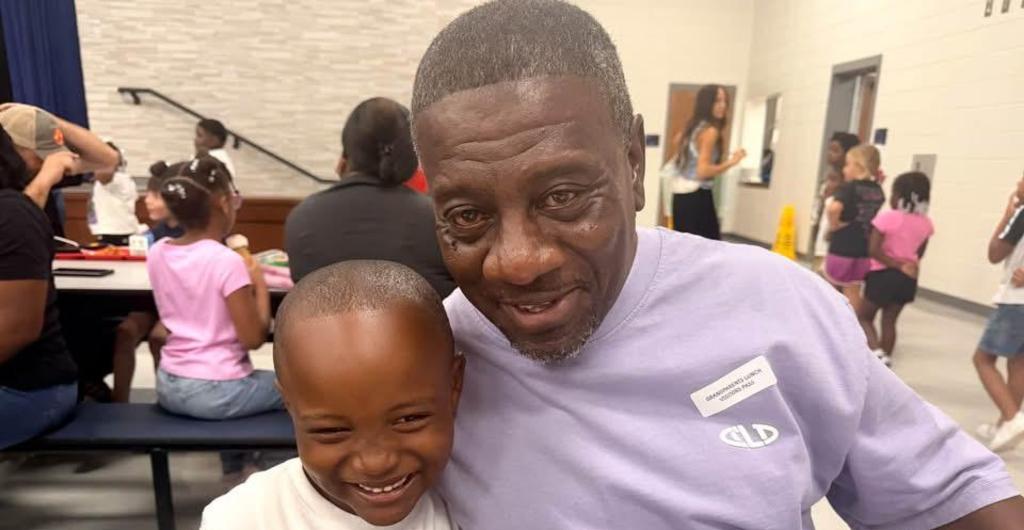 Student poses with Grandfather at lunch
