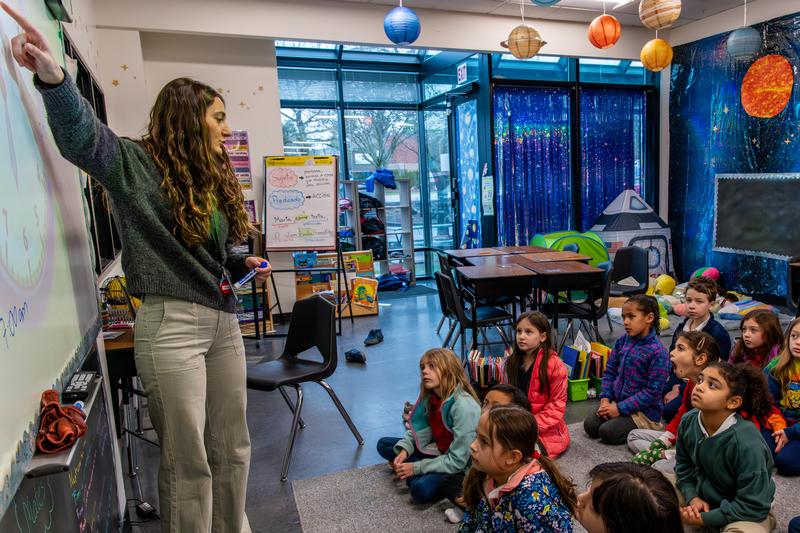 Arco Iris teacher and students learn together in their classroom.