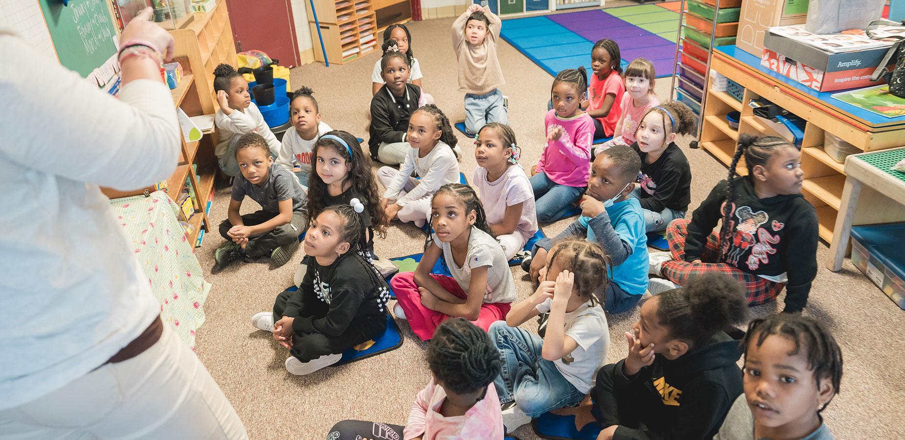 elementary students on rug