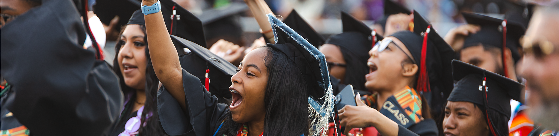 high school graduates in caps and gowns