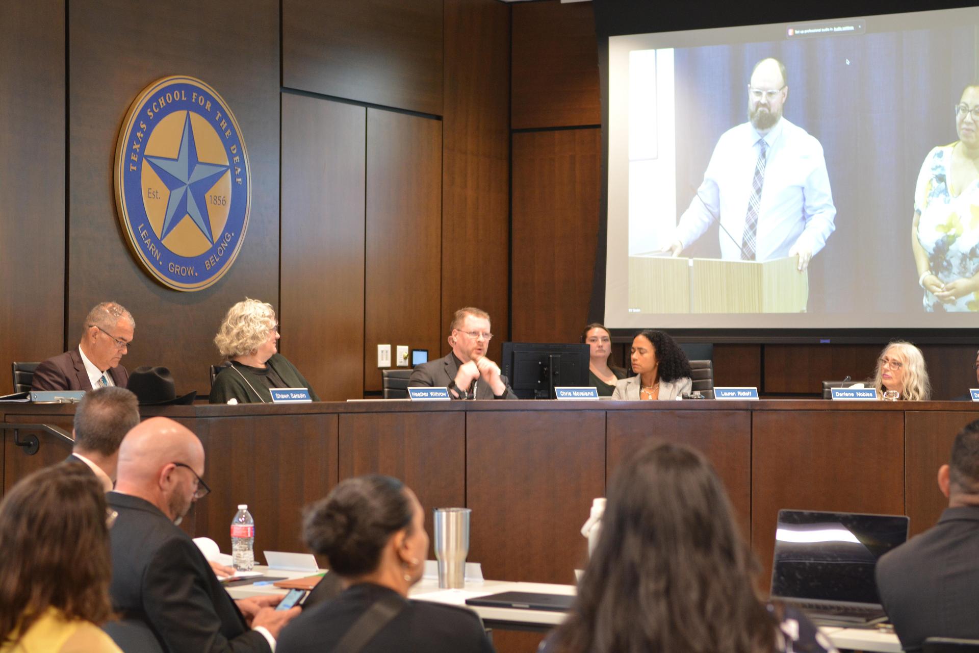Board reviews presentation from guest speakers.”