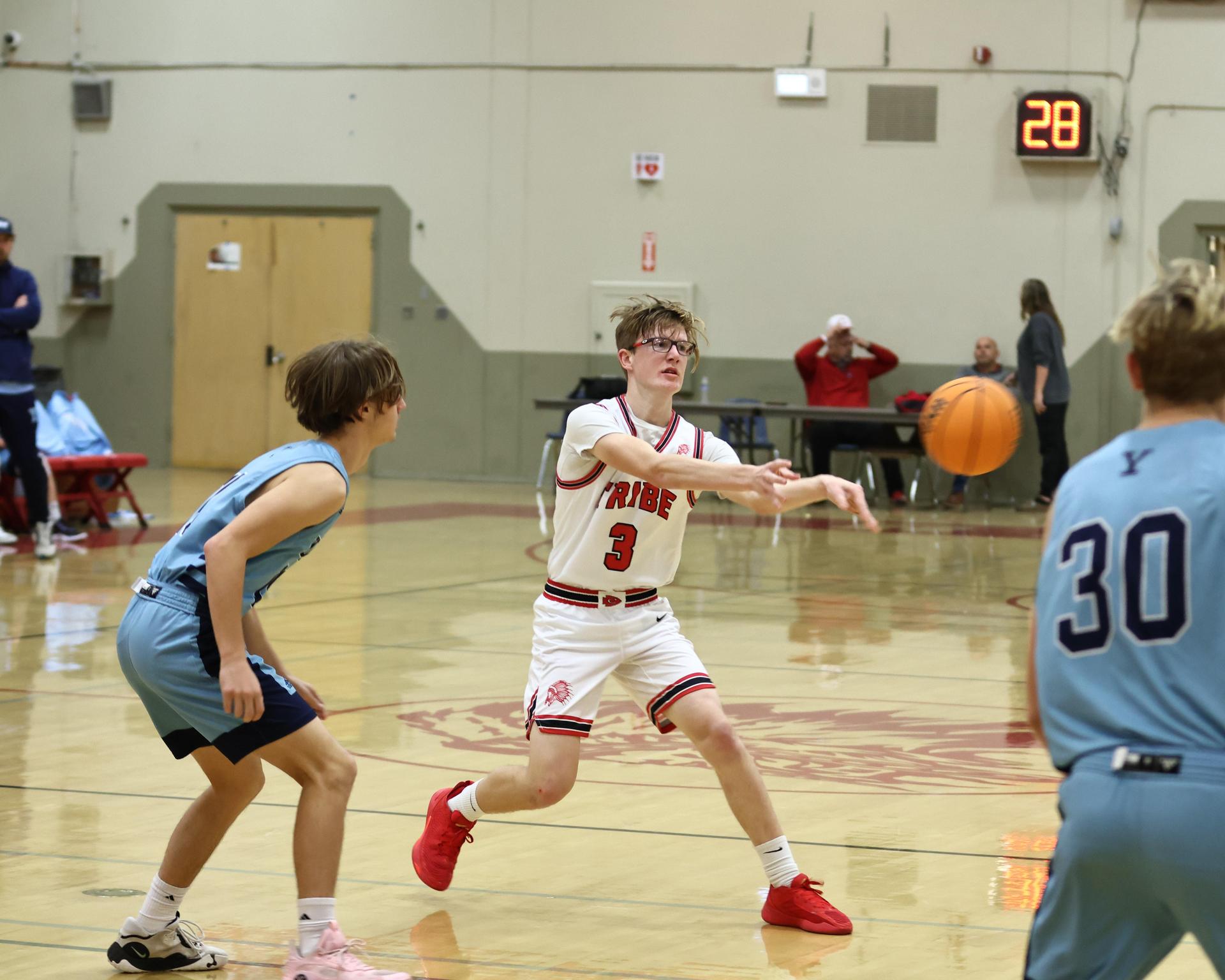 Varsity boys playing basketball against yosemite
