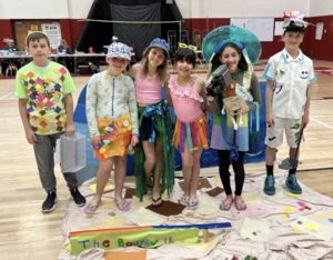 Image depicts students in costume in a gymnasium at the Odyssey of the Mind competition.