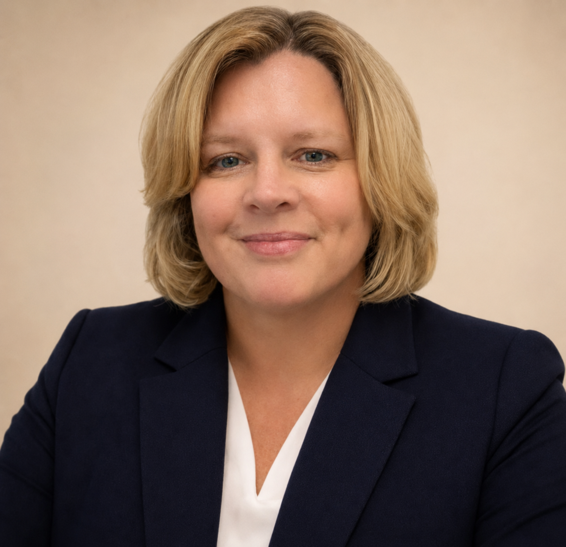 Portrait of a smiling Supt. Vaughan wearing a light-colored blazer and blue blouse.