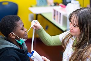 nurse taking a student's temperature