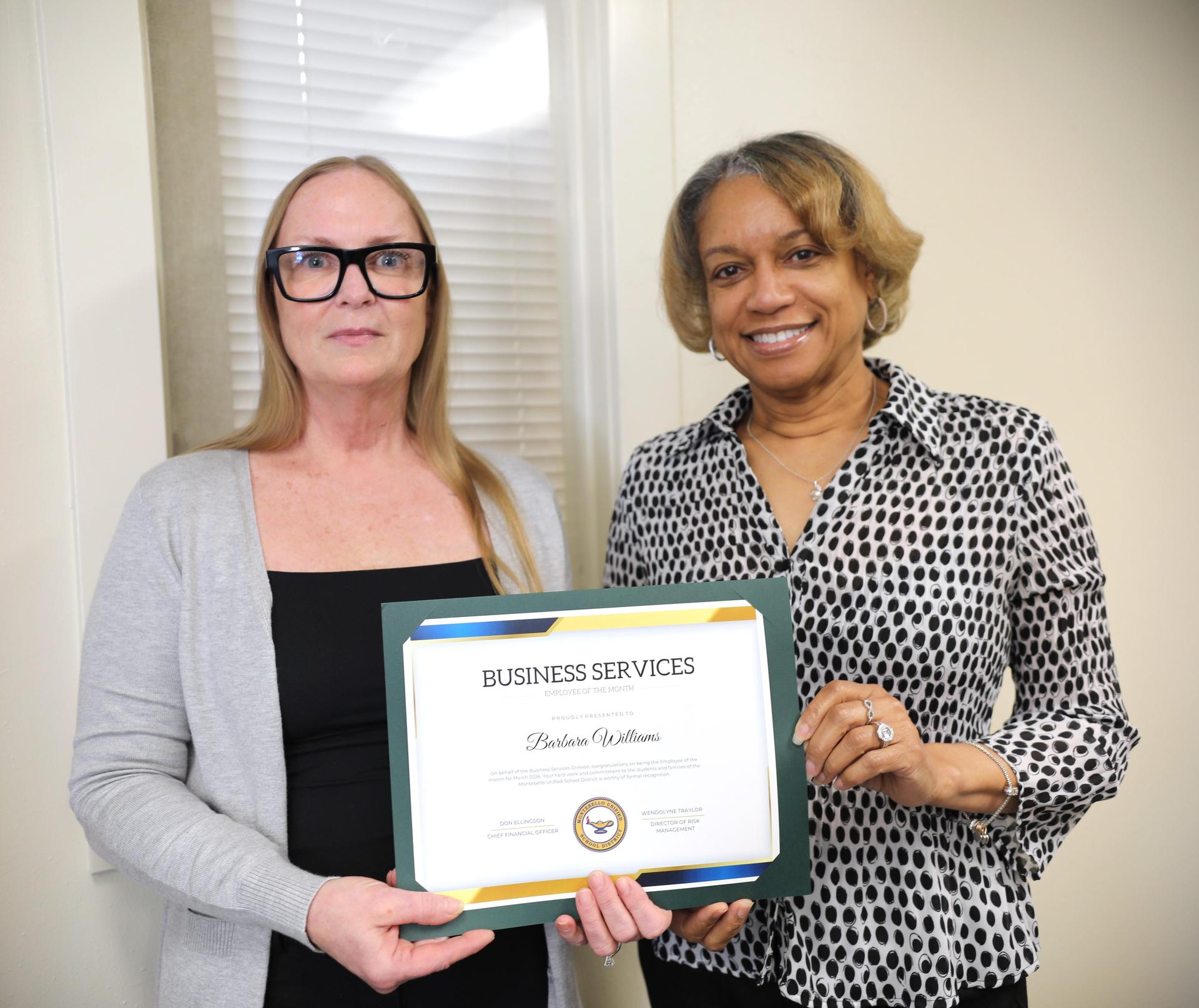 Picture of employee holding certificate 