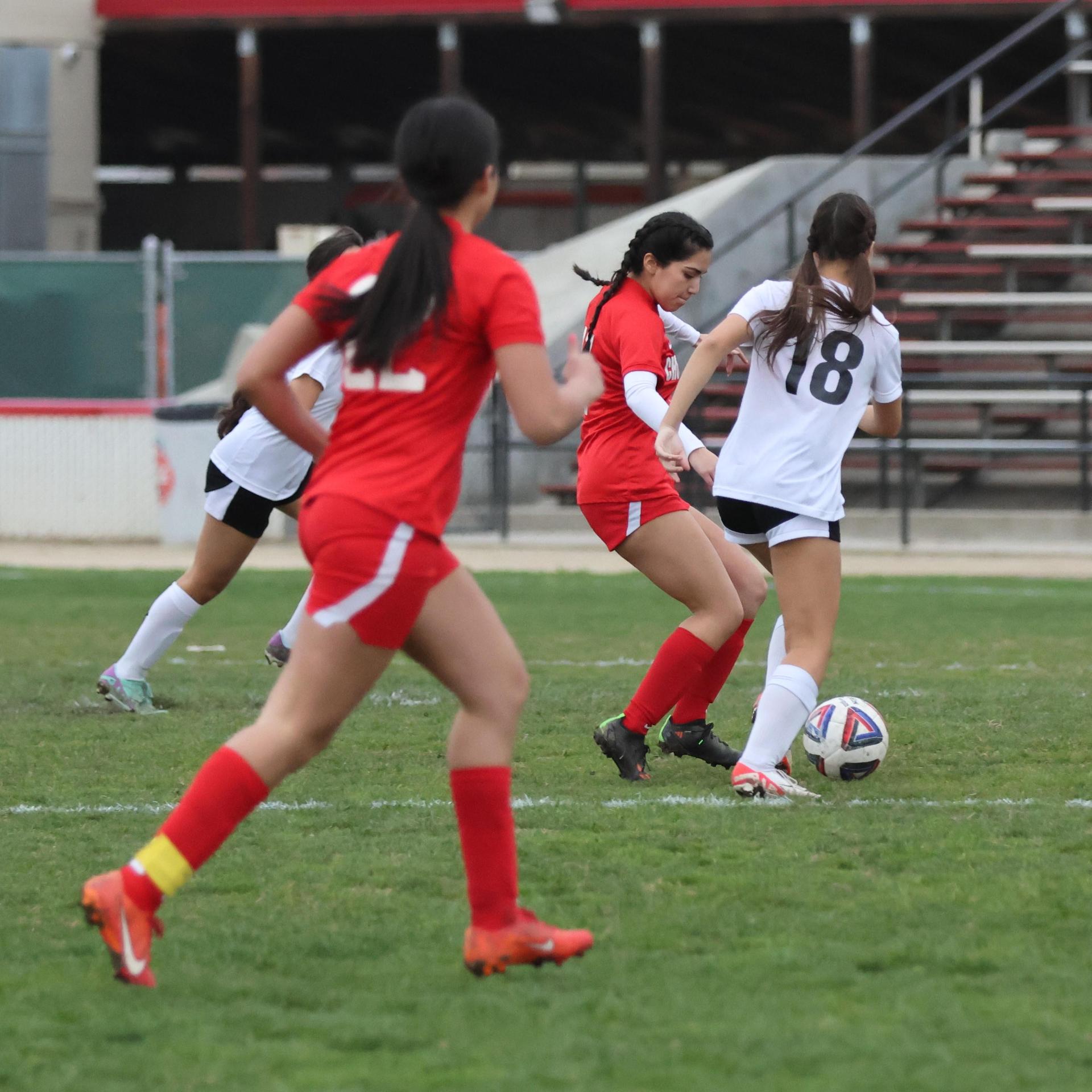 Junior Varisty girls playing soccer against liberty