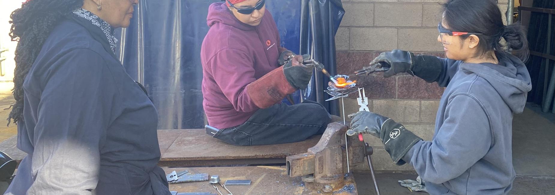 Welding students creating a flower