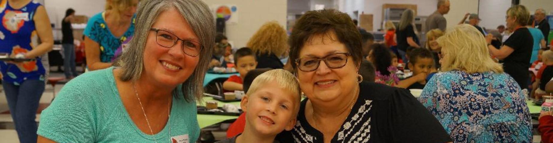 Grandparents enjoy breakfast with their grandchild at Mayfield Elementary