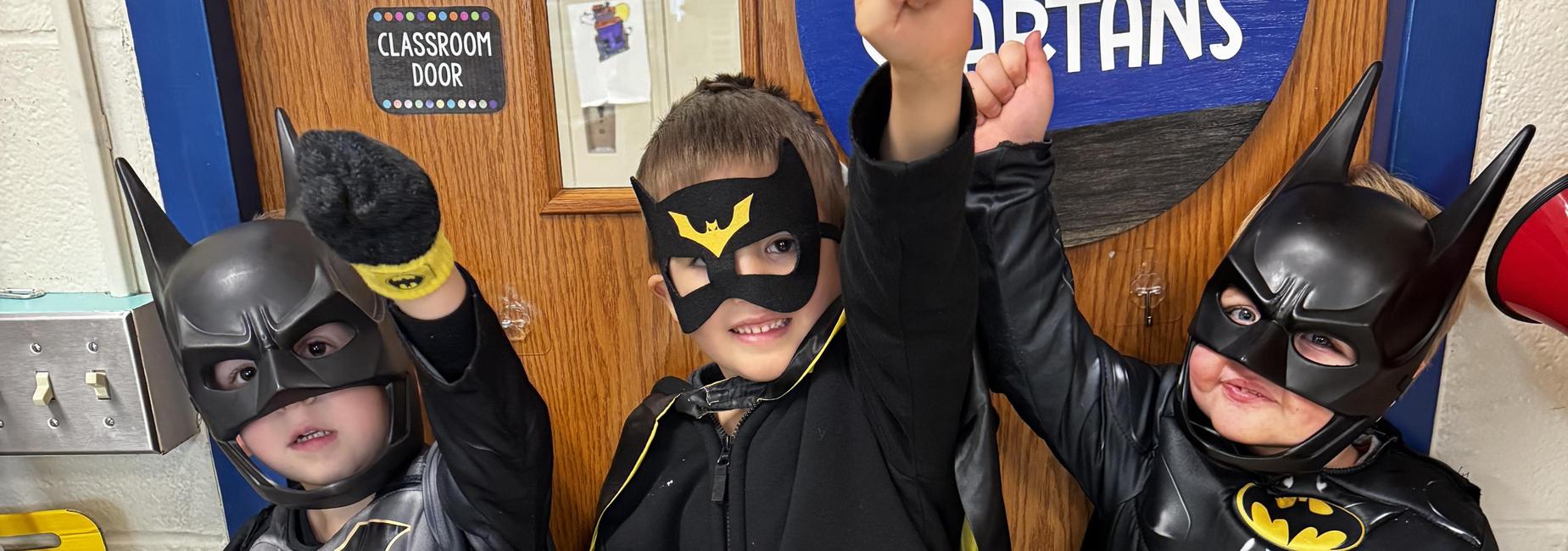 3 students dressed as Batman