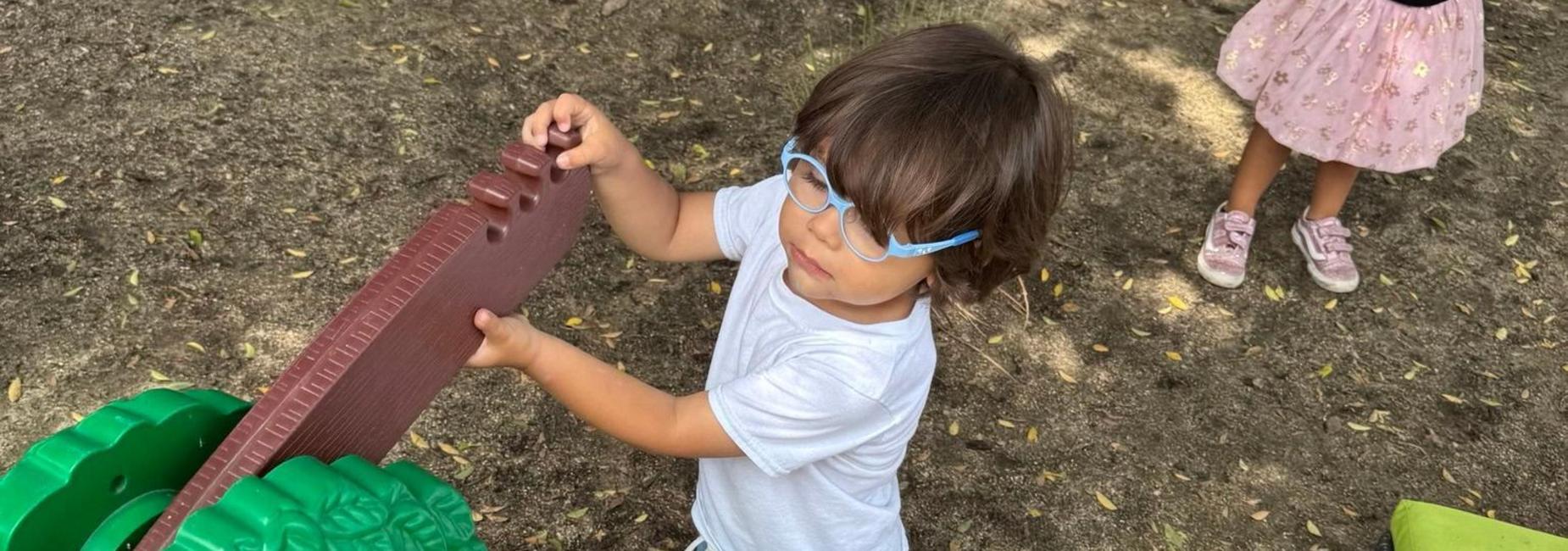 Child playing with tree scale