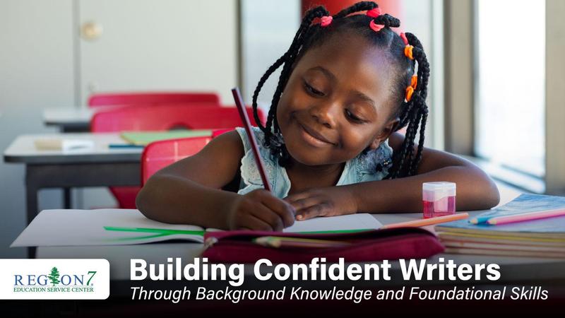 young, happy girl writing in a book on her desk inside of a classroom