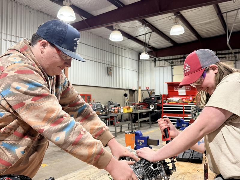 two students holding device