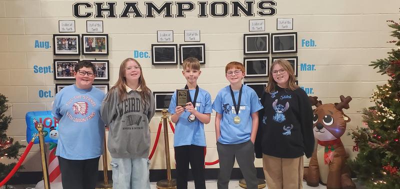 UCMS 6th Grade Academic Team members with award medals and trophy