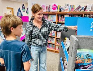 student and teacher at book fair