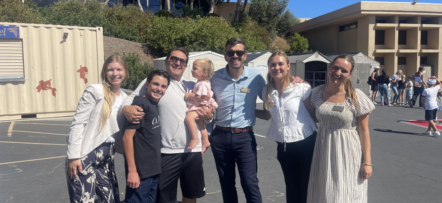 new middle school student posing with middle school teachers