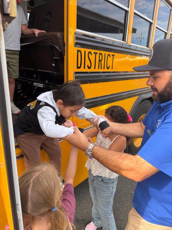 Kid exits bus through emergency exit