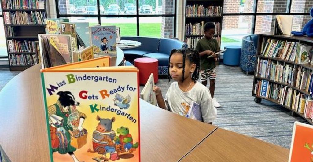 Student looking for book in the media center