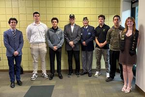 the students who are entering the military stand together for recognition at the May 11 board meeting