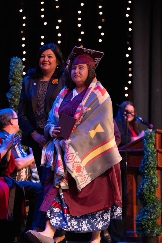 Adult School Graduate receiving blanket from Tule River Tribe