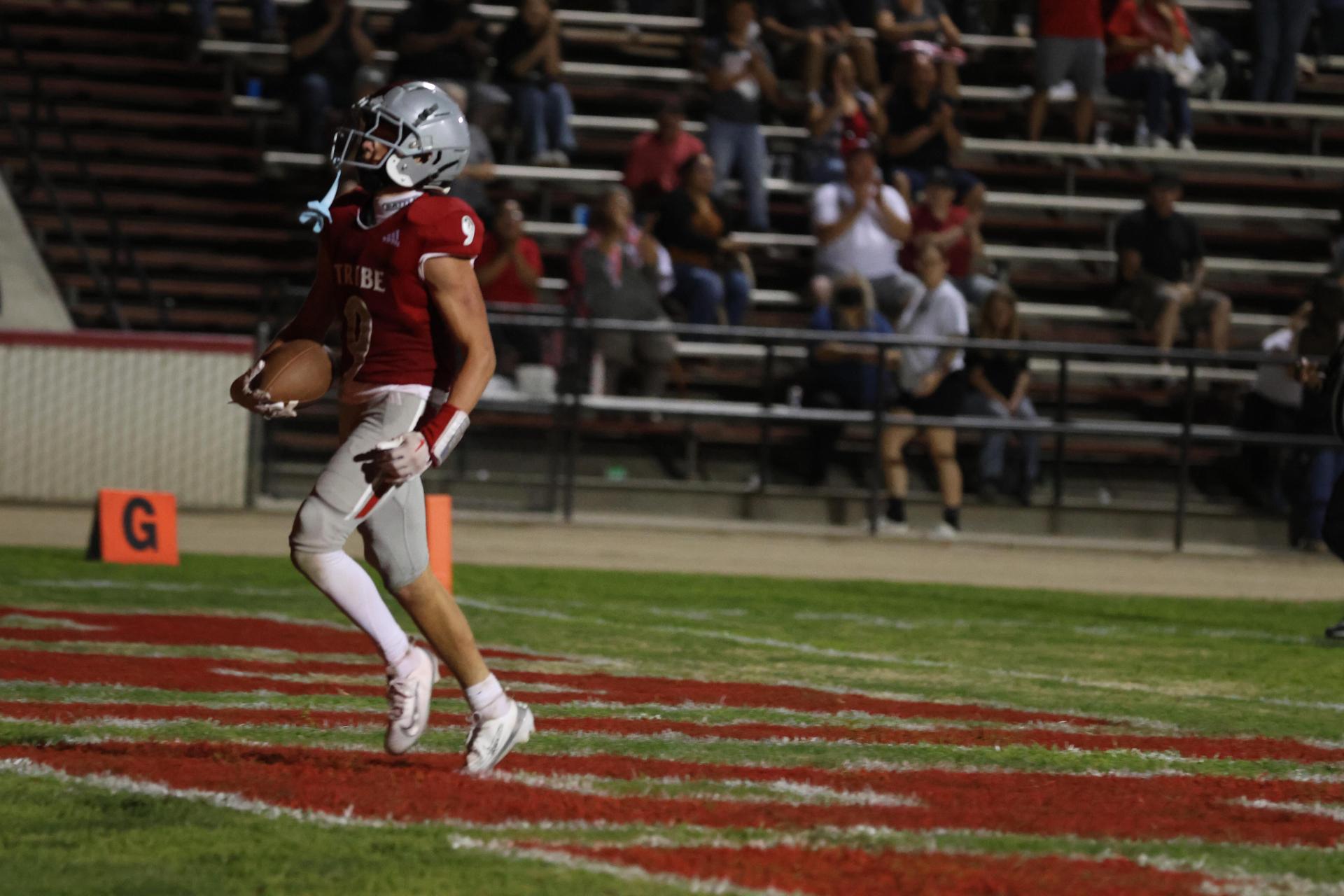 Varsity football players in action against Parlier 55