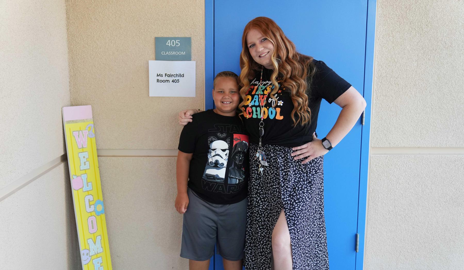 Student and teacher standing by classroom door