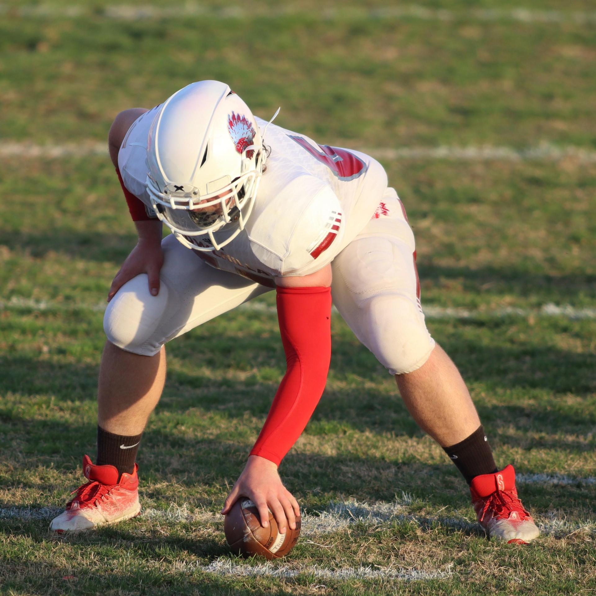 Junior Varsity football players in action against Caruthers