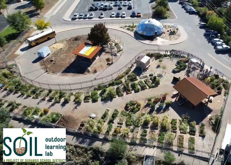 Aerial view of a garden site under construction, with the SOIL Outdoor Learning Lab logo in the bottom left.