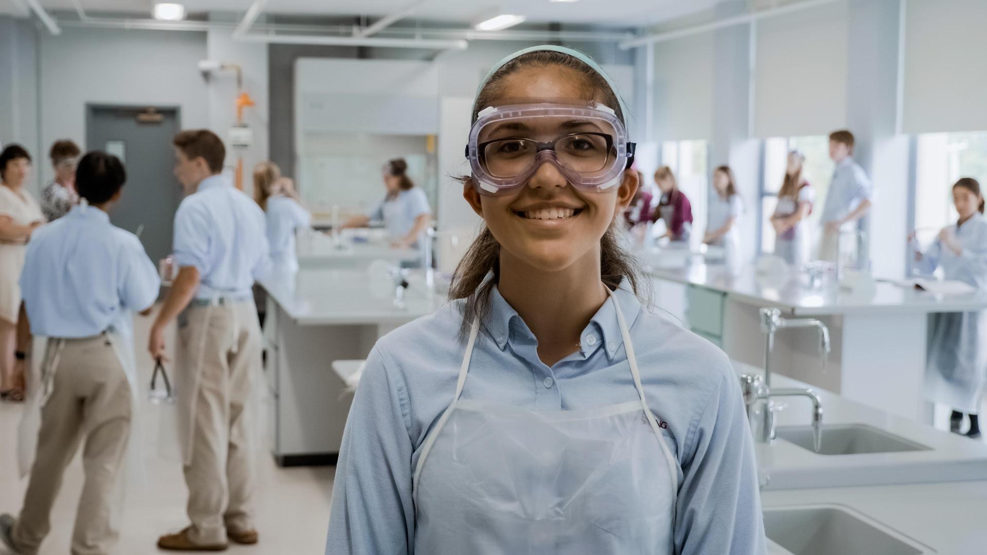 Student with goggles in science lab