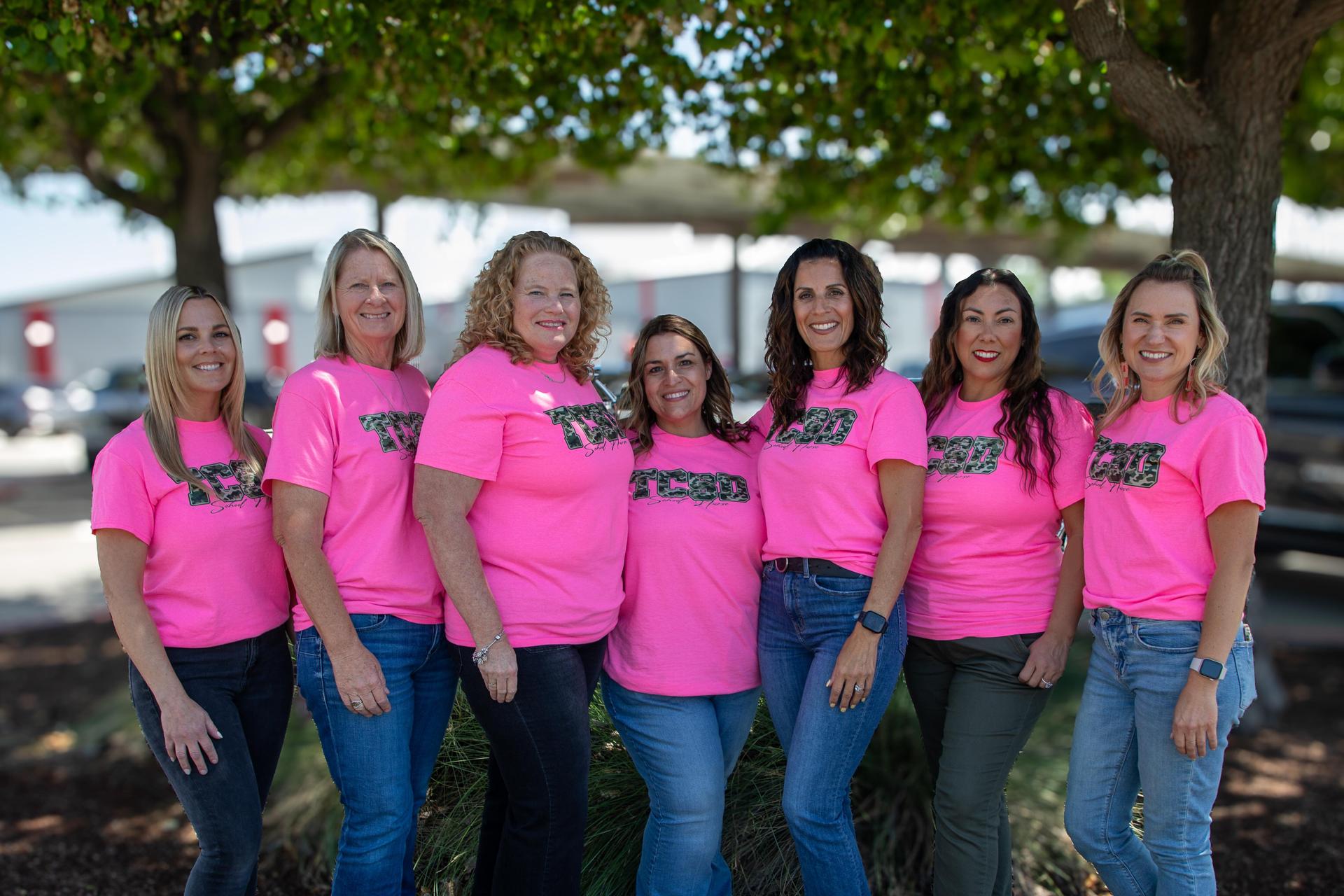 Group of TCSD nursing staff in pink shirts standing outdoors