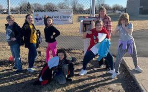photo - Justice Intermediate School students pose by the school's Little Free Library