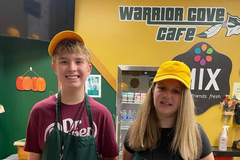 8th-graders Dylan Landram and Brylee Lawson work behind the counter of the snack shop