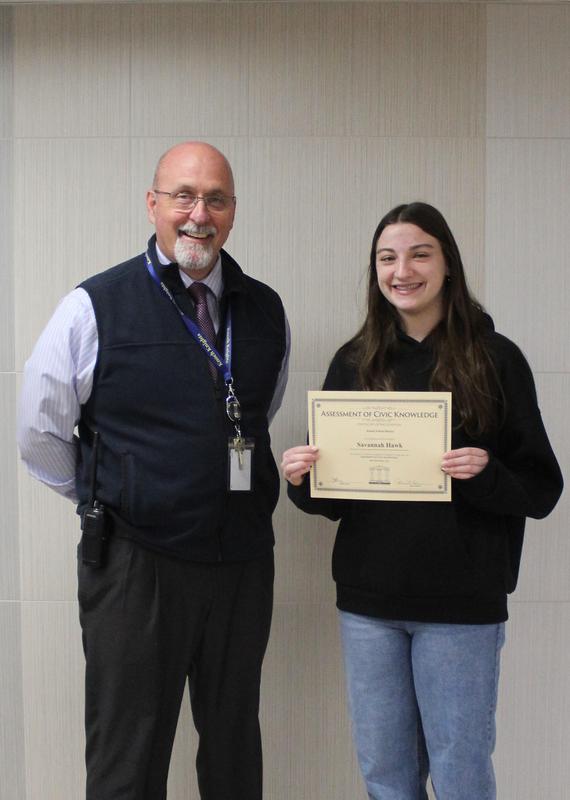pic of  principal and a girl holding a certificate