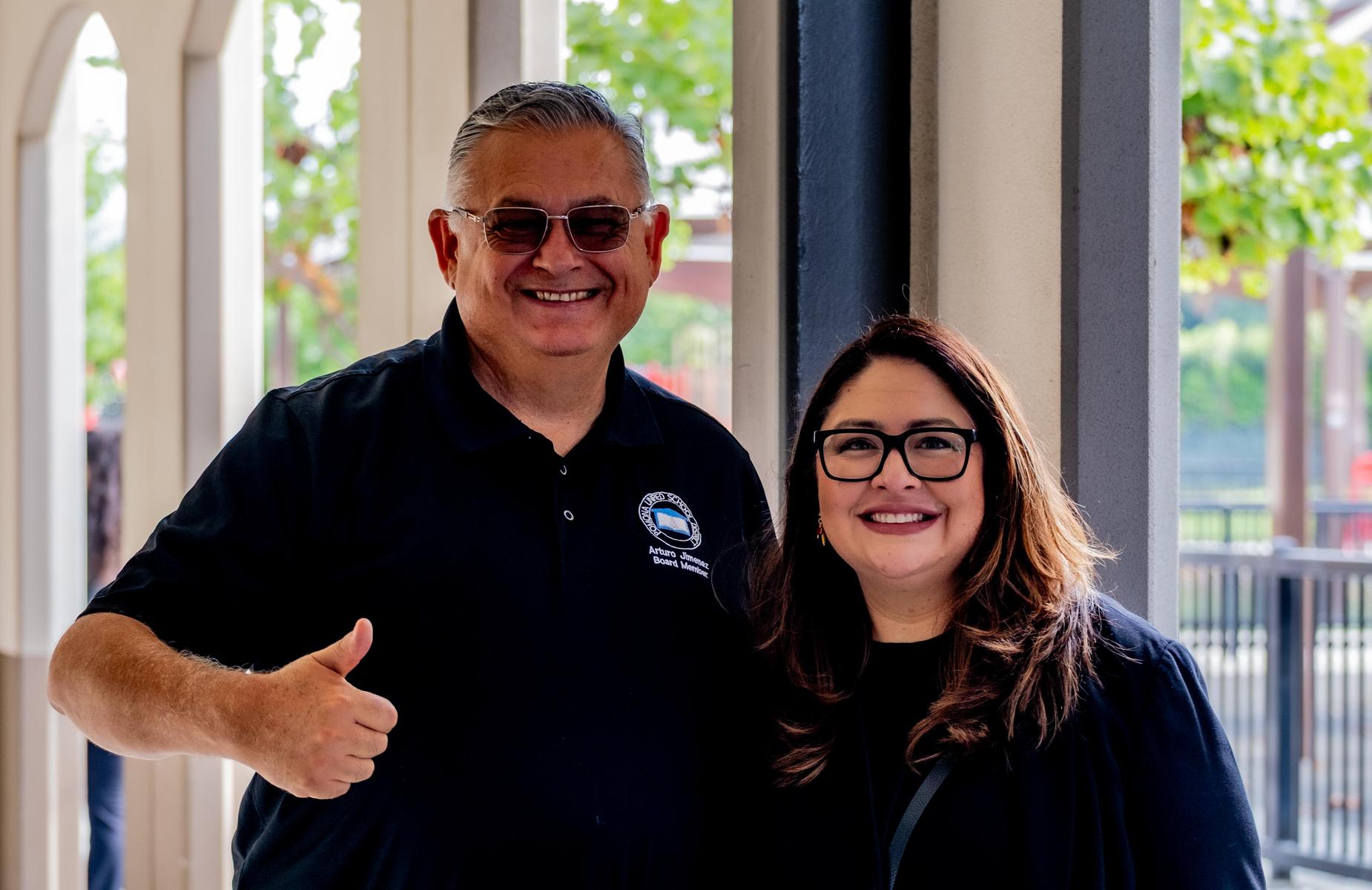 Board member giving thumbs up and Washington principal