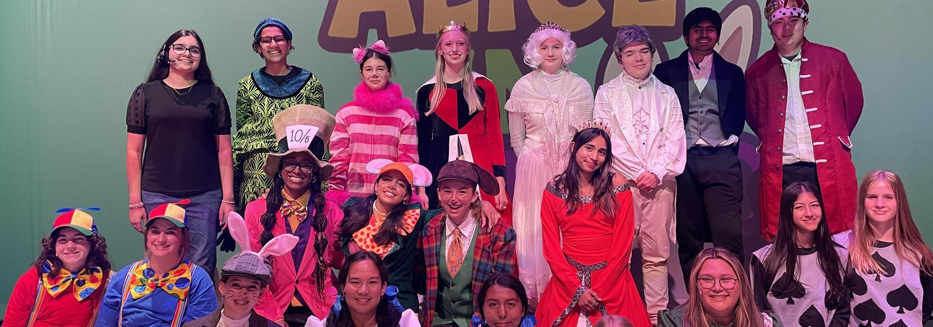 A group photo of all the theatre students, in costume, that participated in the production, Alice in Wonderland.