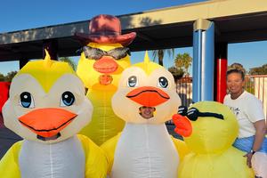 four staff members in inflatable duck costumes