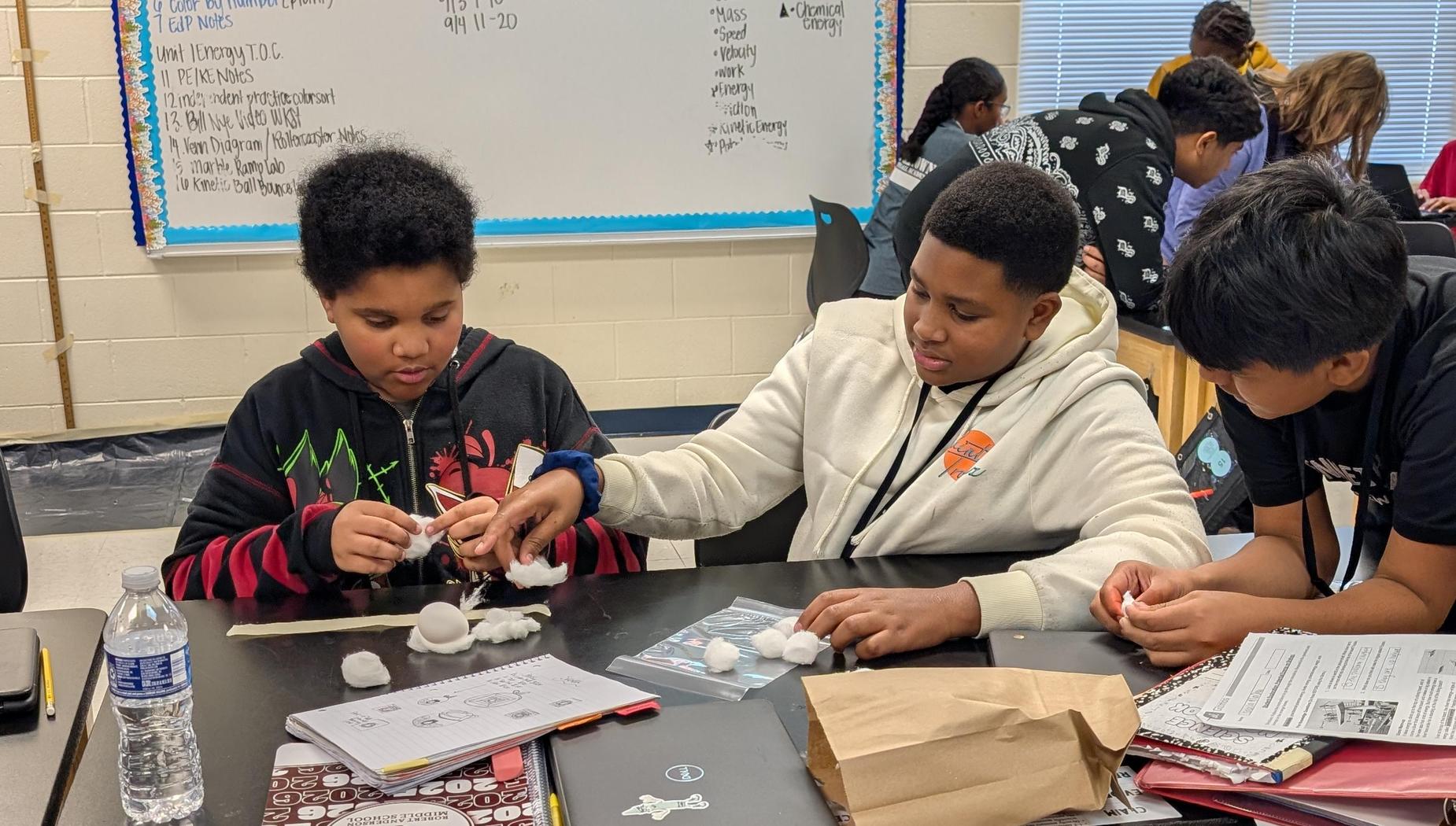 7th graders making a protective case for an egg