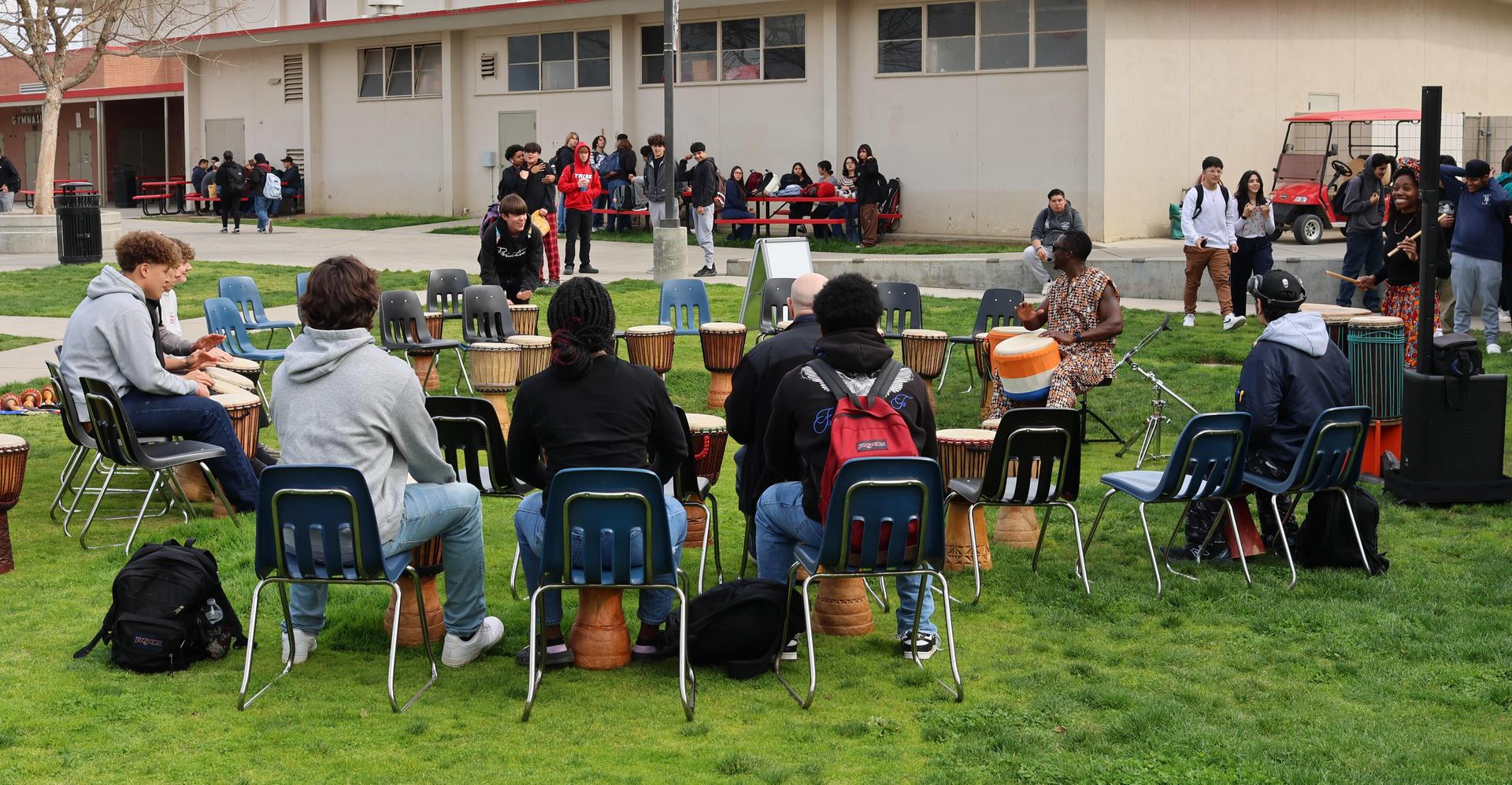 students and staff participating with the African Drum Interactive