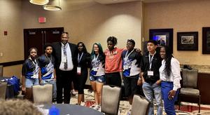 Cayden, Emmalee, and their peers with a guest speaker