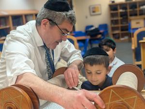 Boy looking at torah