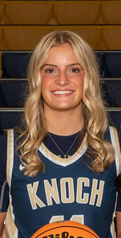 girl basketball player in uniform with long blonde hair